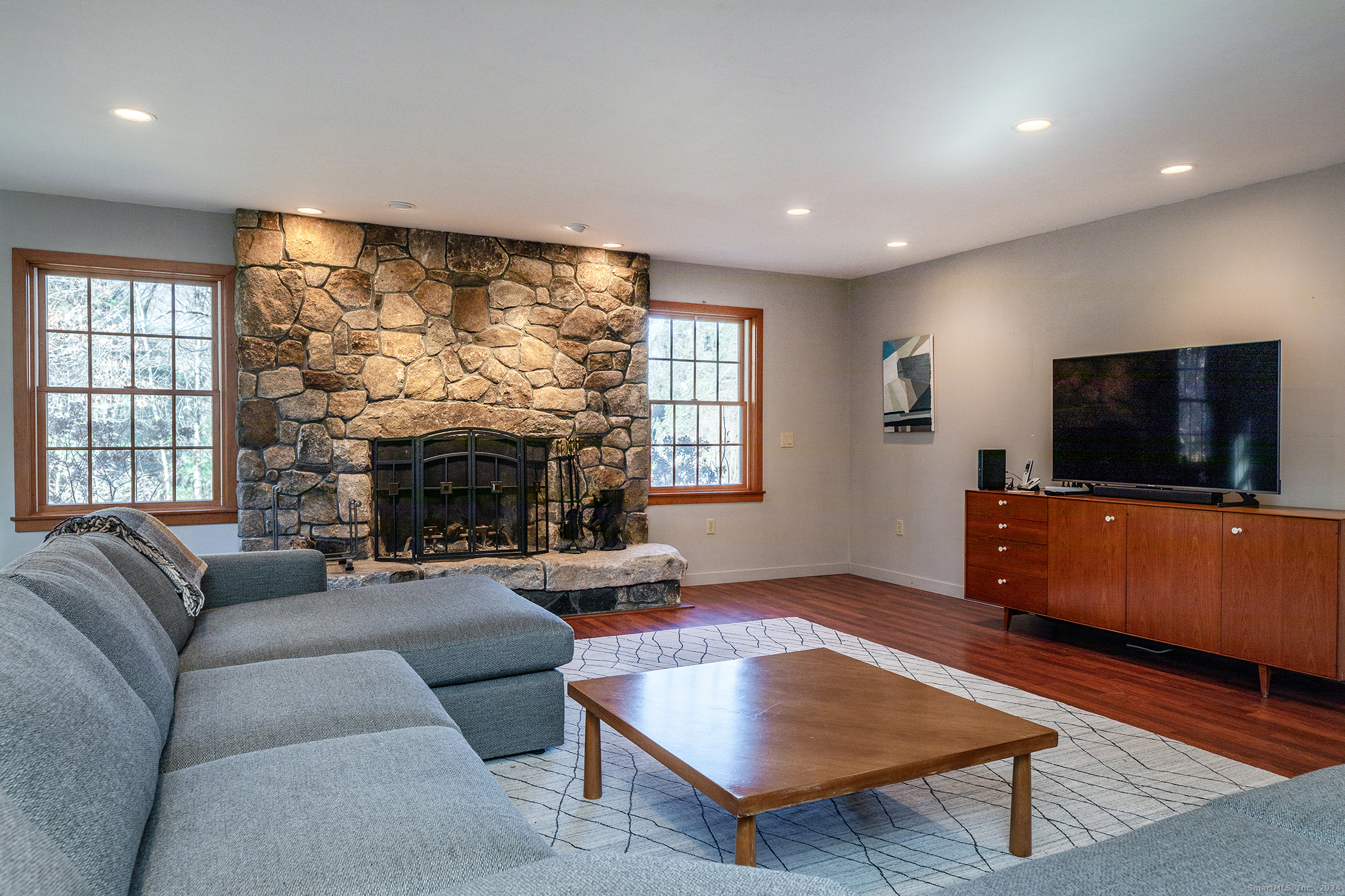 28 Headquarters Road Litchfield, CT 06759 - Photo 4 of 28 a living room with furniture a flat screen tv and a large window