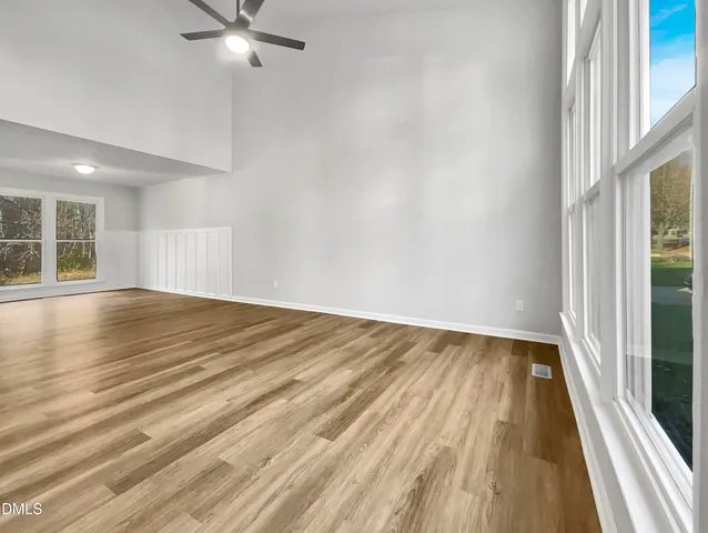 wooden floor in an empty room with a window