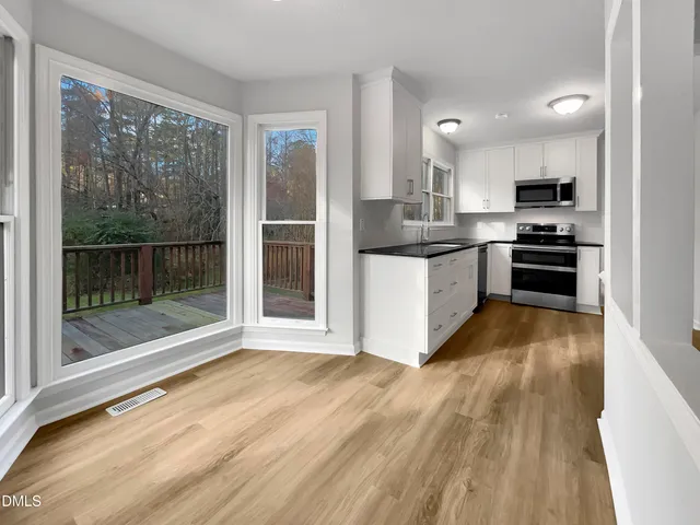 a kitchen with stainless steel appliances granite countertop a stove top oven and sink