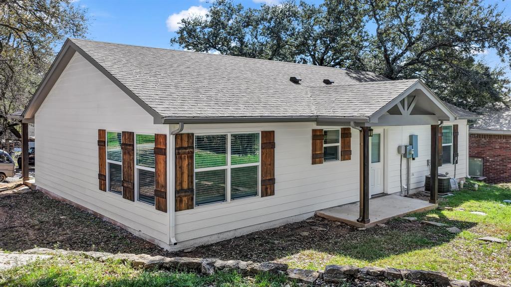 1830 Hitching Post Road Granbury, TX 76049 - Photo 12 of 34 a view of a house with a yard and large windows