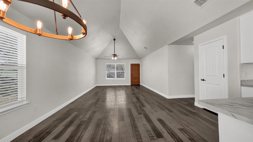 1830 Hitching Post Road Granbury, TX 76049 - Photo 13 of 34 a view of a hallway with wooden floor and staircase