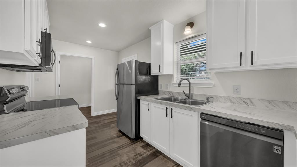 1830 Hitching Post Road Granbury, TX 76049 - Photo 15 of 34 a kitchen with a sink a refrigerator and a stove