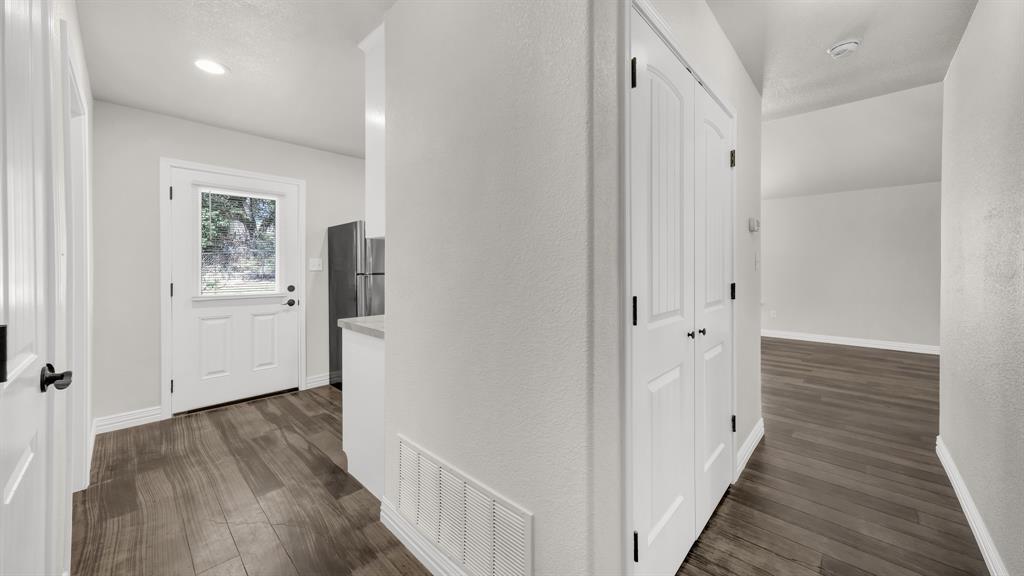 1830 Hitching Post Road Granbury, TX 76049 - Photo 20 of 34 a view of a hallway with wooden floor