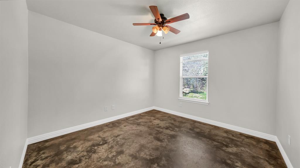 1830 Hitching Post Road Granbury, TX 76049 - Photo 25 of 34 an empty room with a window and a fan