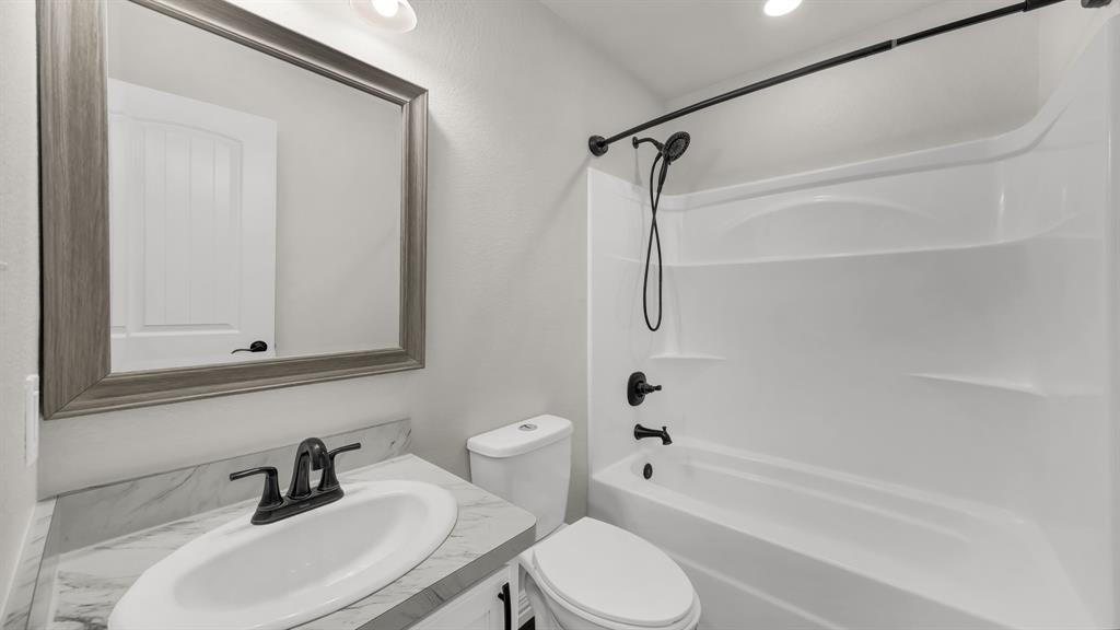 1830 Hitching Post Road Granbury, TX 76049 - Photo 27 of 34 a bathroom with a sink toilet and shower