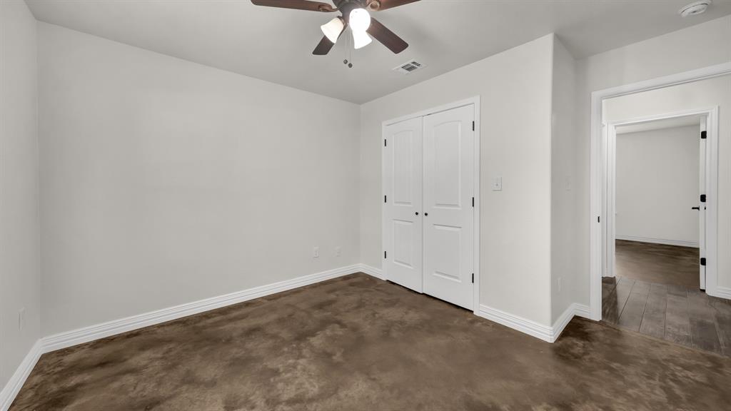 1830 Hitching Post Road Granbury, TX 76049 - Photo 29 of 34 an empty room with a ceiling fan and carpet