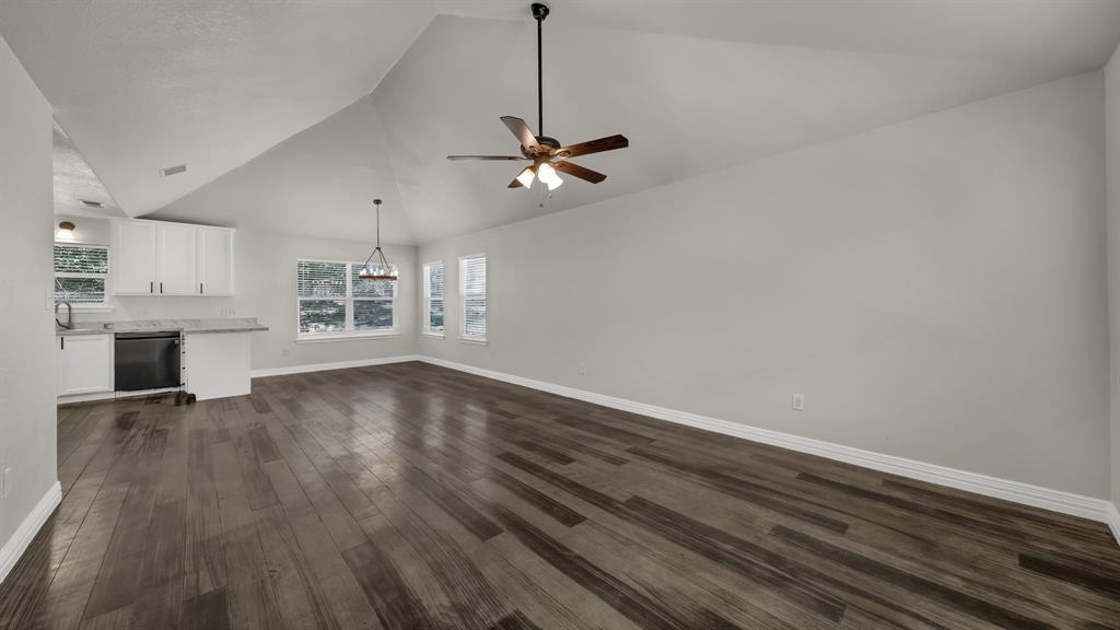 1830 Hitching Post Road Granbury, TX 76049 - Photo 4 of 34 a view of empty room with wooden floor and ceiling fan
