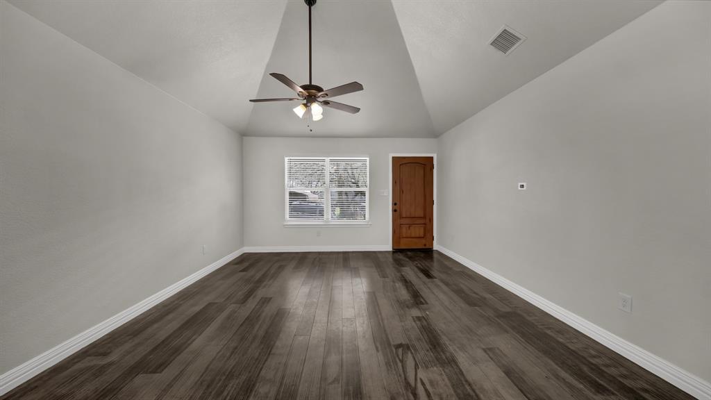 1830 Hitching Post Road Granbury, TX 76049 - Photo 7 of 34 wooden floor in an empty room with a window