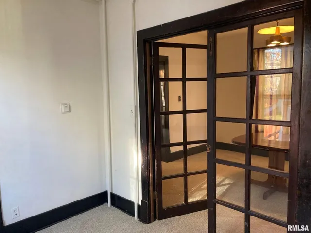 a room with pool table and windows