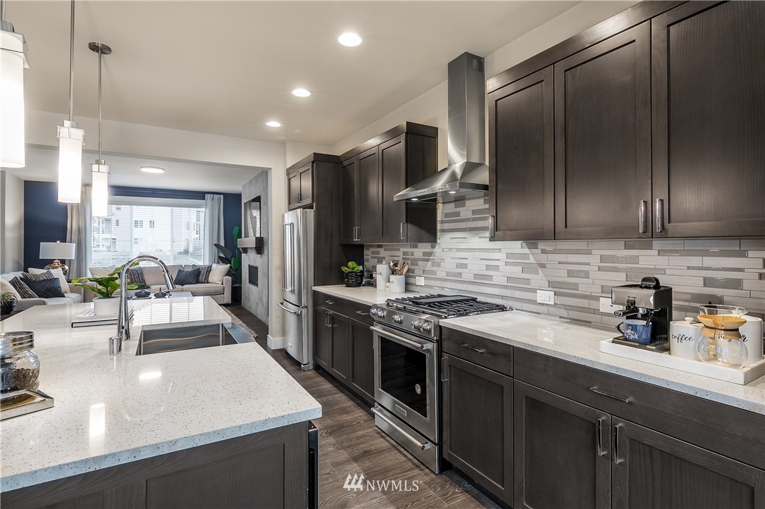 23205 89th Avenue West, Unit 8 Edmonds, WA 98026 - Photo 13 of 37 a kitchen with stainless steel appliances granite countertop a sink stove and refrigerator