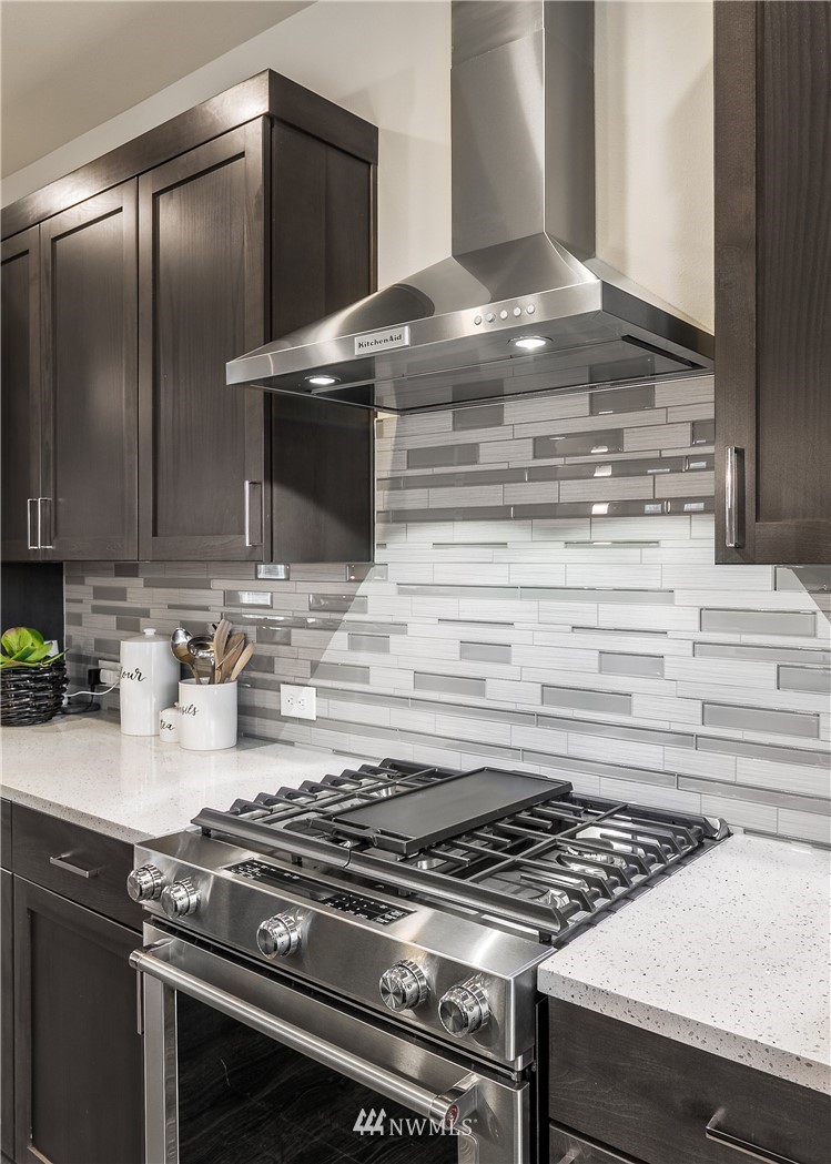 23205 89th Avenue West, Unit 8 Edmonds, WA 98026 - Photo 21 of 37 a stove top oven sitting inside of a kitchen