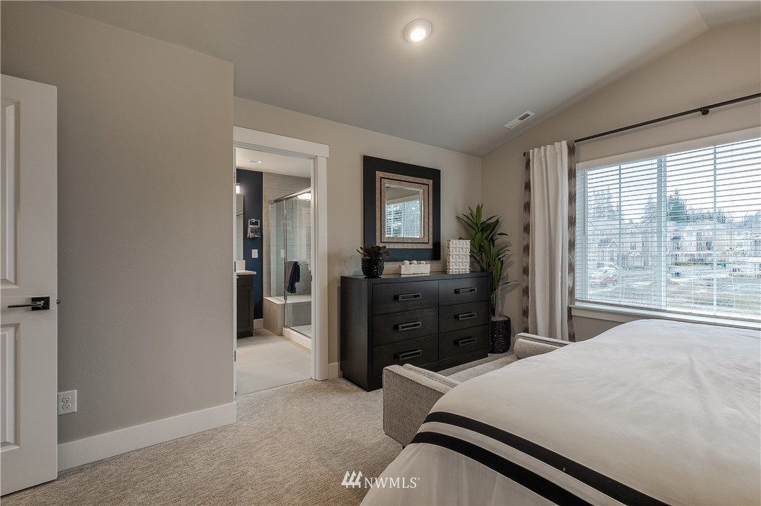 23205 89th Avenue West, Unit 8 Edmonds, WA 98026 - Photo 27 of 37 a bedroom with a bed and large windows