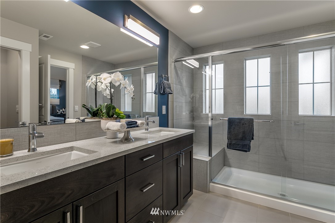 23205 89th Avenue West, Unit 8 Edmonds, WA 98026 - Photo 29 of 37 a bathroom with a double vanity sink and mirror with bathtub