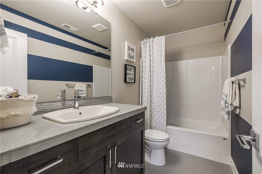 23205 89th Avenue West, Unit 8 Edmonds, WA 98026 - Photo 35 of 37 a bathroom with a sink a toilet and shower