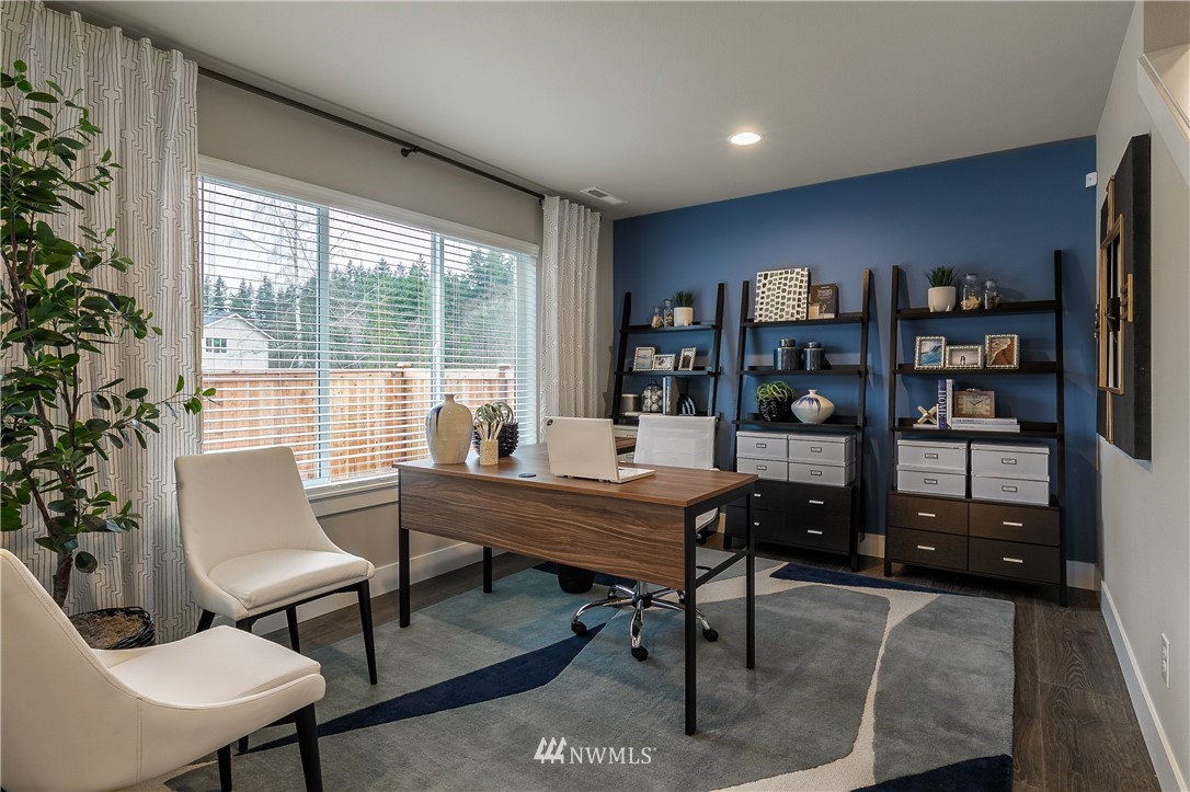 23205 89th Avenue West, Unit 8 Edmonds, WA 98026 - Photo 5 of 37 a view of a workspace with furniture and a potted plant