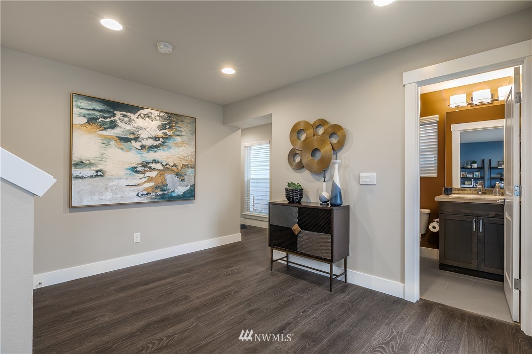 23205 89th Avenue West, Unit 8 Edmonds, WA 98026 - Photo 6 of 37 a view of a hallway with wooden floor and a workspace