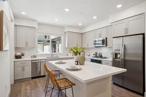 a kitchen with a sink a stove and cabinets
