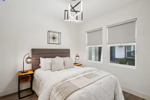 a bedroom with a bed and a chandelier