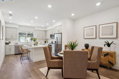 a dining room with furniture and wooden floor