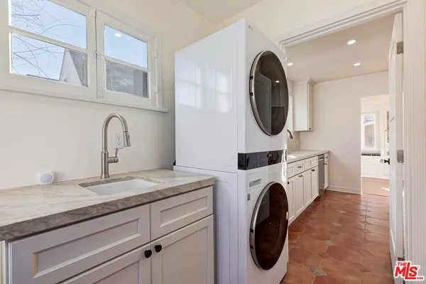 a utility room with sink dryer and washer