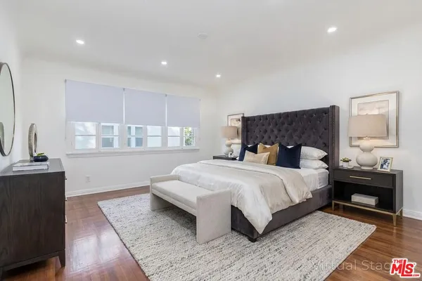 a bedroom with a large bed and a table