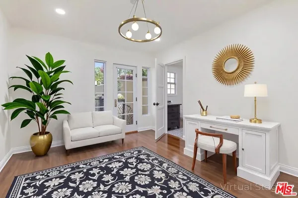 a living room with furniture potted plant and window