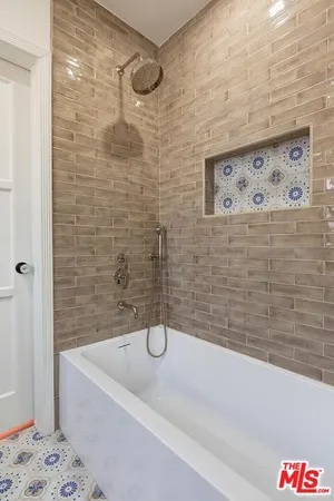 a bathroom with a bathtub and shower