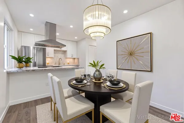 a view of a dining room with furniture and wooden floor