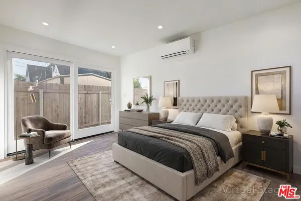 a bedroom with a bed and a view of living room