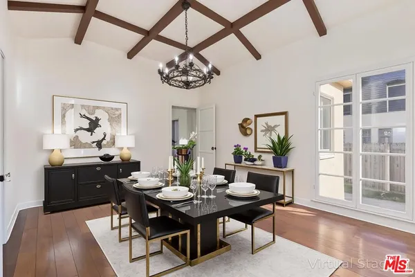 a view of a dining room with furniture wooden floor and a chandelier