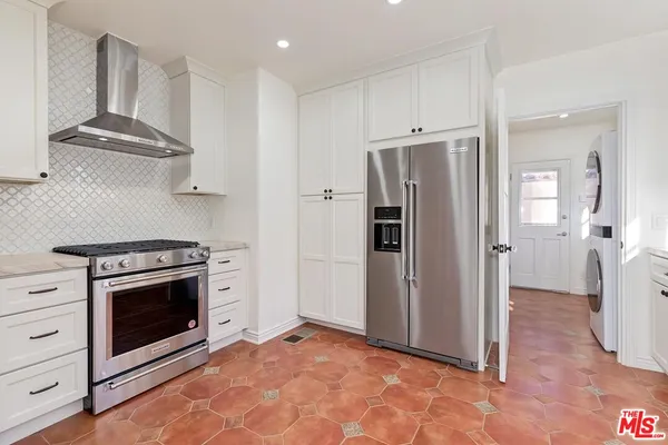 a view of a kitchen with stainless steel appliances and cabinets