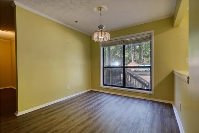 a view of an empty room with a fireplace and window