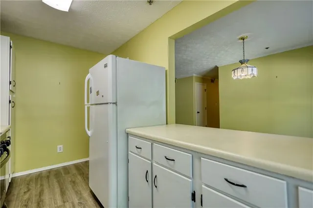 a view of a kitchen with wooden floor and a window