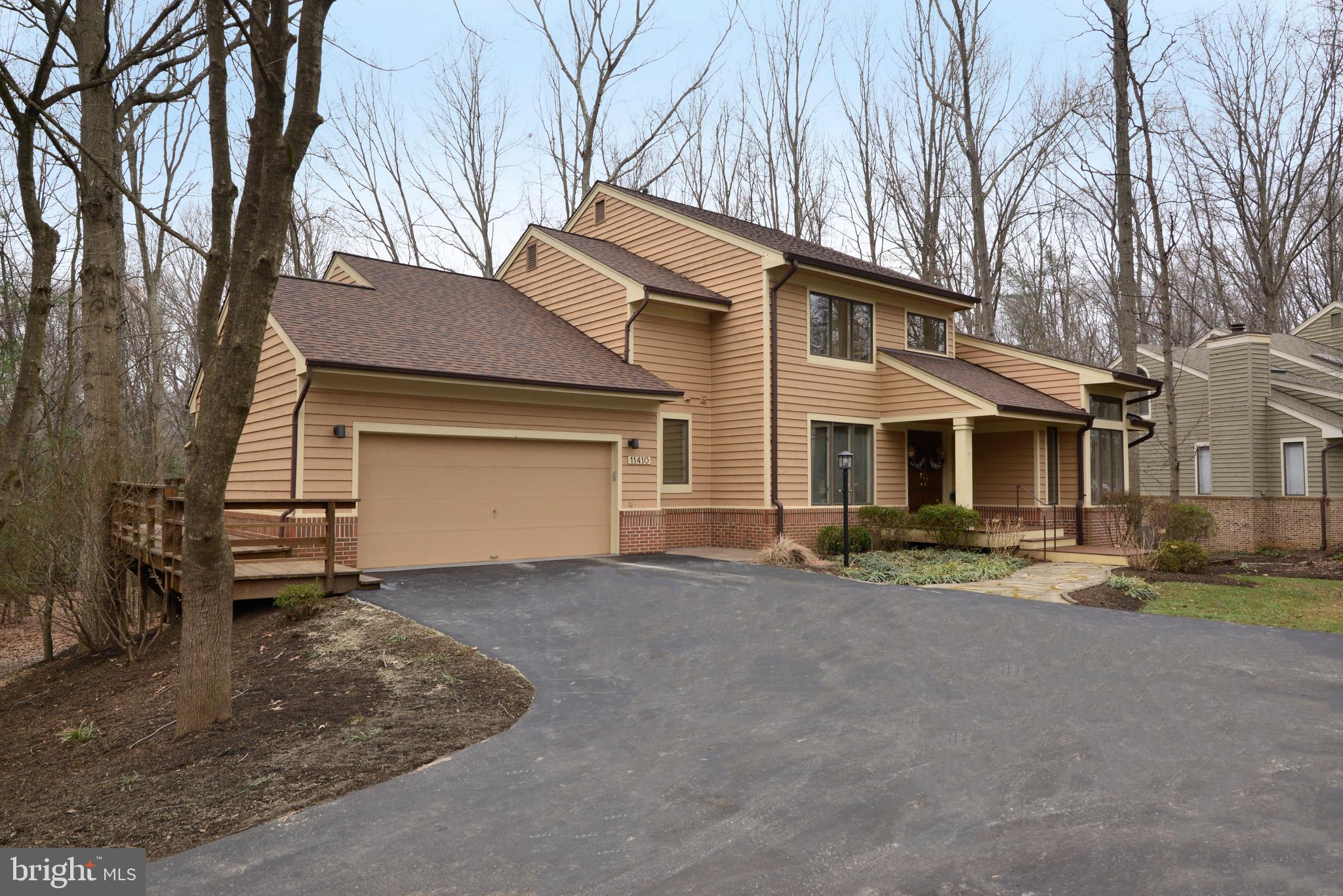 11410 Fieldstone Lane Reston, VA 20191 - Photo 3 of 50 a front view of a house with a yard and garage