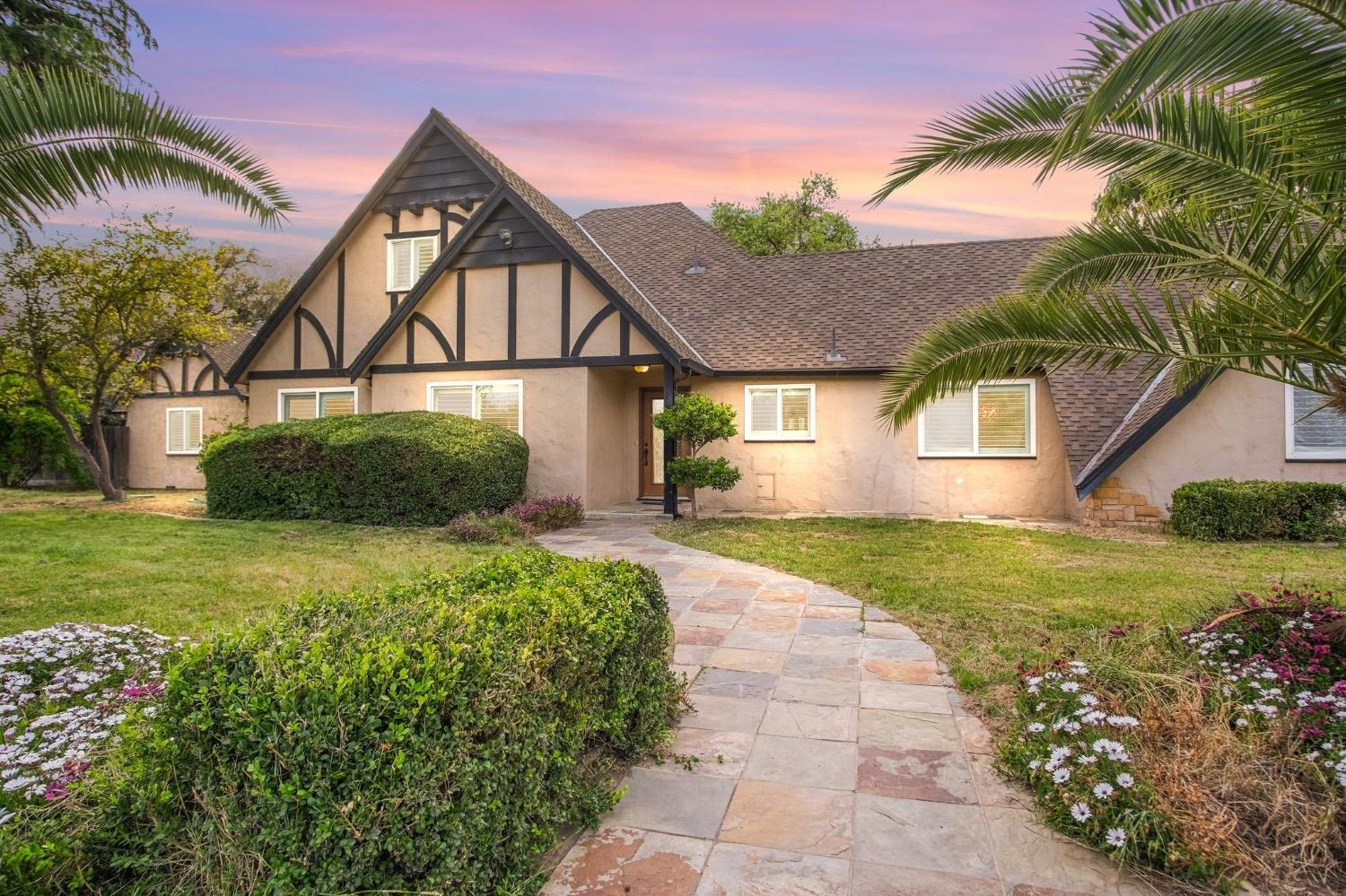 a front view of a house with a garden