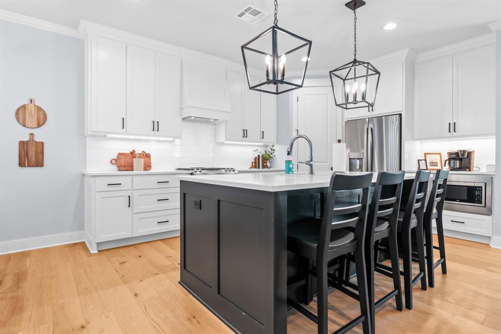 421 Proctor Avenue Waco, TX 76708 - Photo 6 of 28 a kitchen with a dining table cabinets and stainless steel appliances