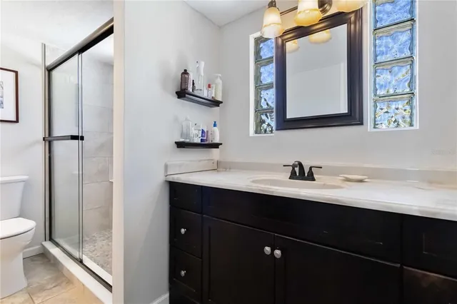 a bathroom with a sink vanity and a mirror