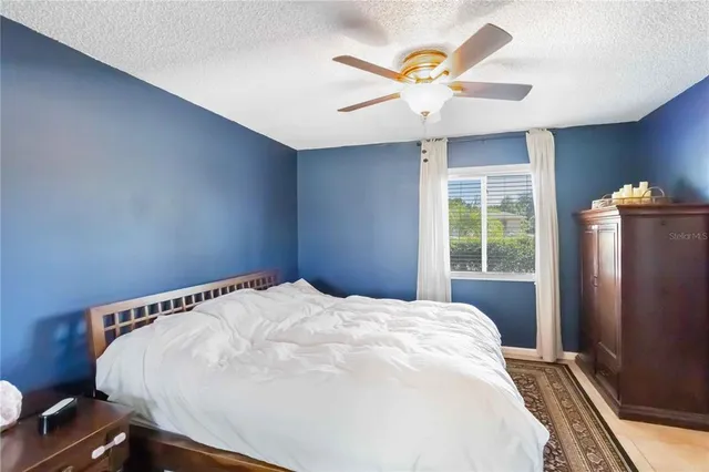 a large bed sitting in a bedroom next to a window