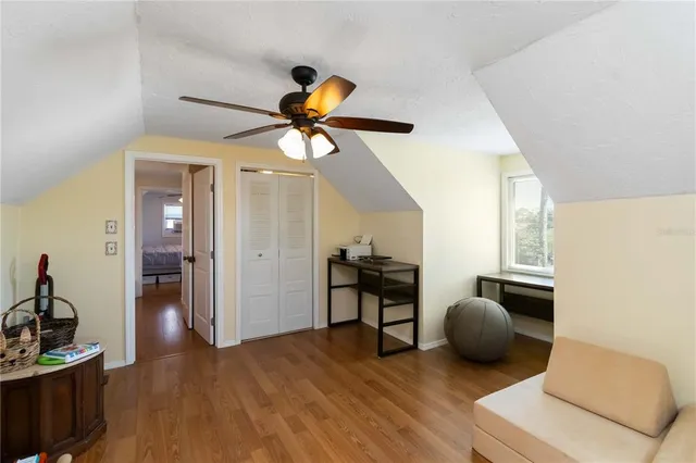 a bedroom with furniture and a wooden floor
