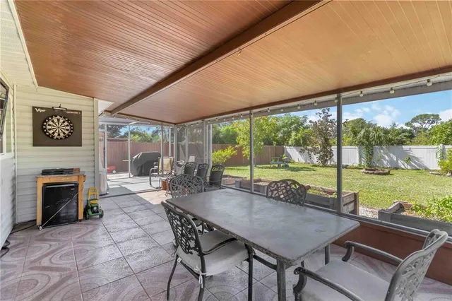 a view of a patio with a table chairs and a backyard