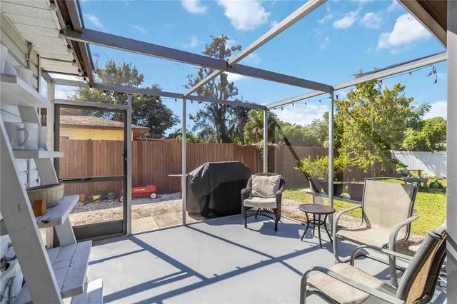 a view of a patio with a dining table and chairs
