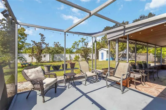 a view of swimming pool with outdoor seating and plants
