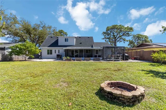 a swimming pool with outdoor seating and yard