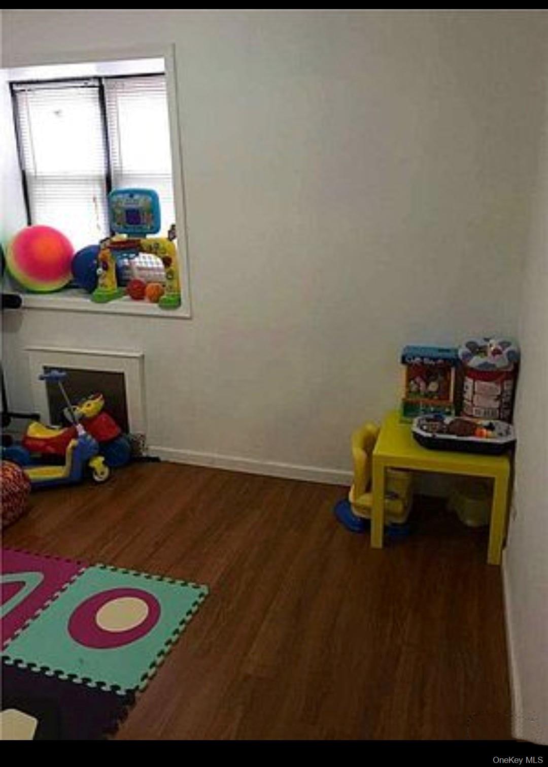 132-35 Sanford Avenue, Unit LD Queens, NY 11355 - Photo 5 of 9 Game room with baseboards and dark wood-style floors