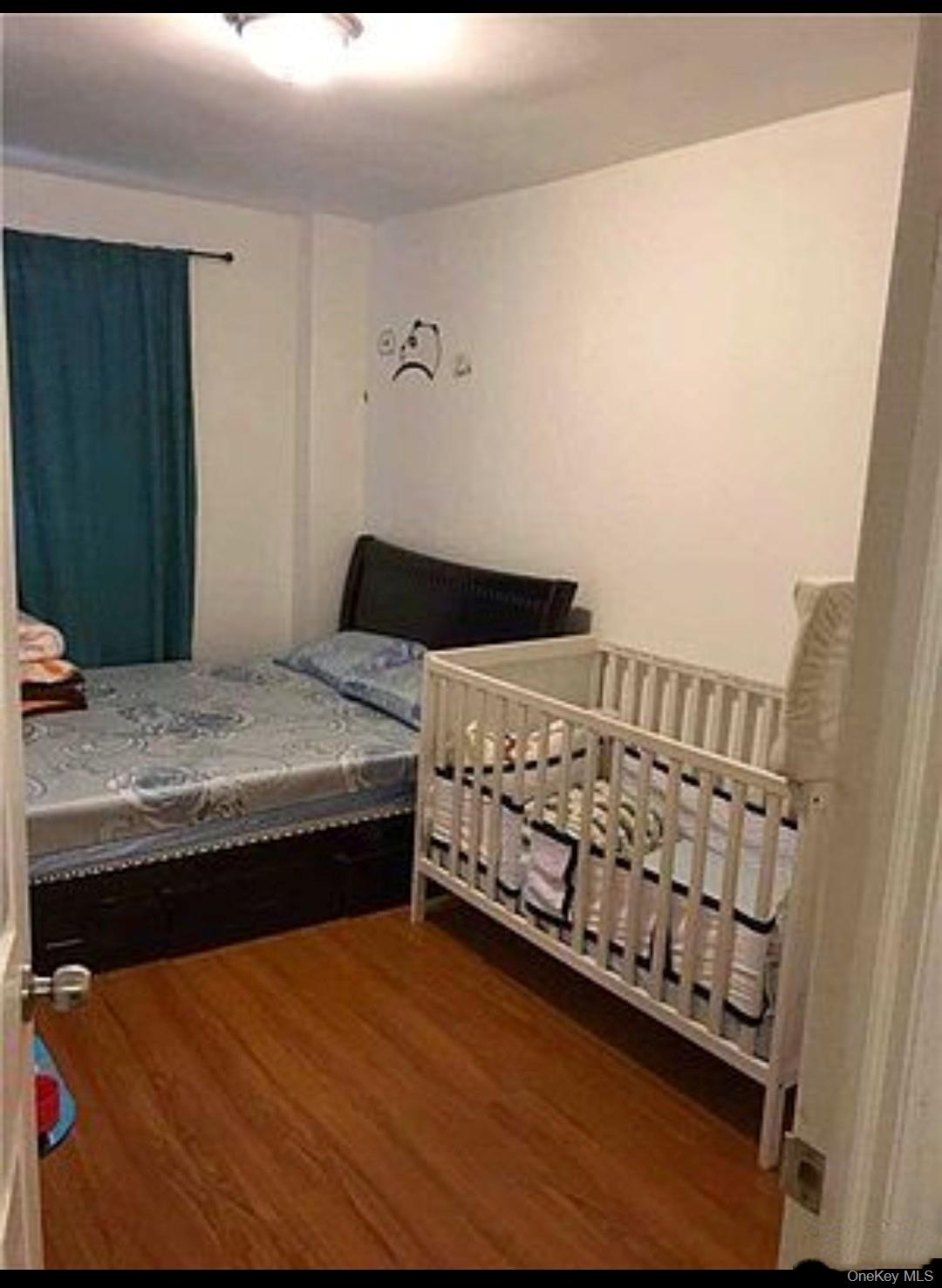 132-35 Sanford Avenue, Unit LD Queens, NY 11355 - Photo 7 of 9 Bedroom featuring dark wood-style flooring