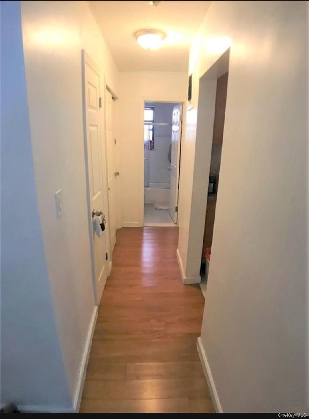 132-35 Sanford Avenue, Unit LD Queens, NY 11355 - Photo 9 of 9 Corridor with light wood-type flooring and baseboards