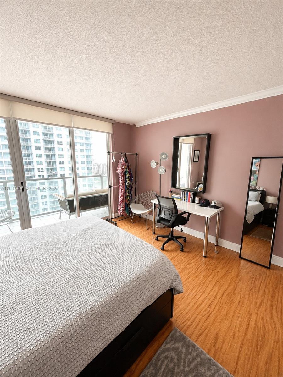 Brickell Miami, FL 33131 - Photo 9 of 19 a bedroom with a bed a large window and chair