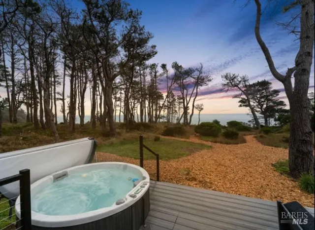 a backyard of a house with a yard and outdoor seating