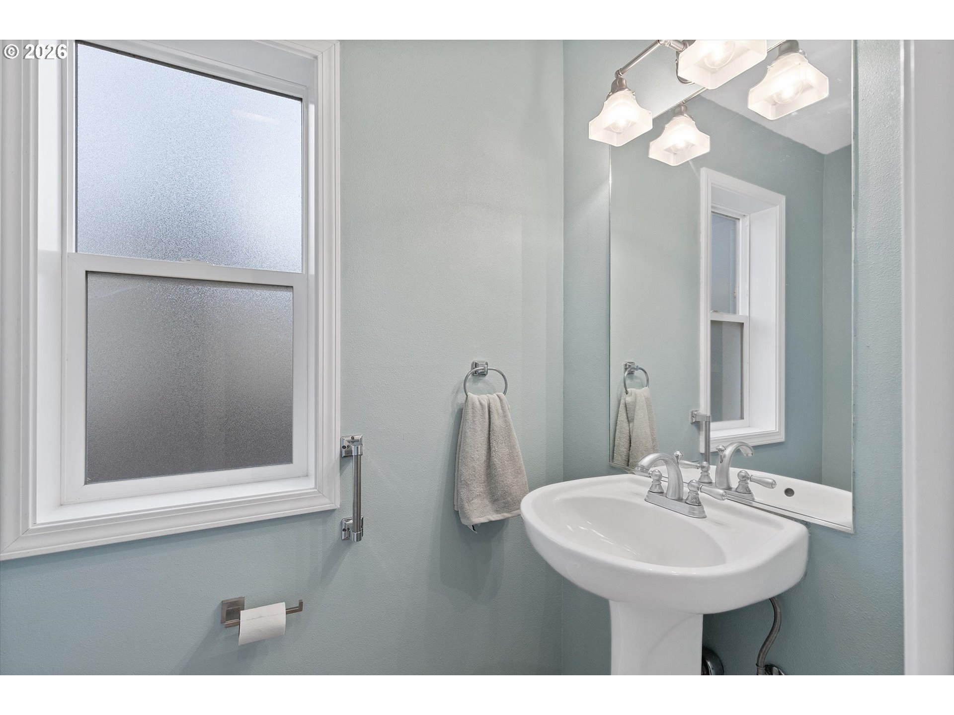 49800 Proposal Rock Loop Neskowin, OR 97149 - Photo 12 of 29 a bathroom with a sink a mirror and a light fixture