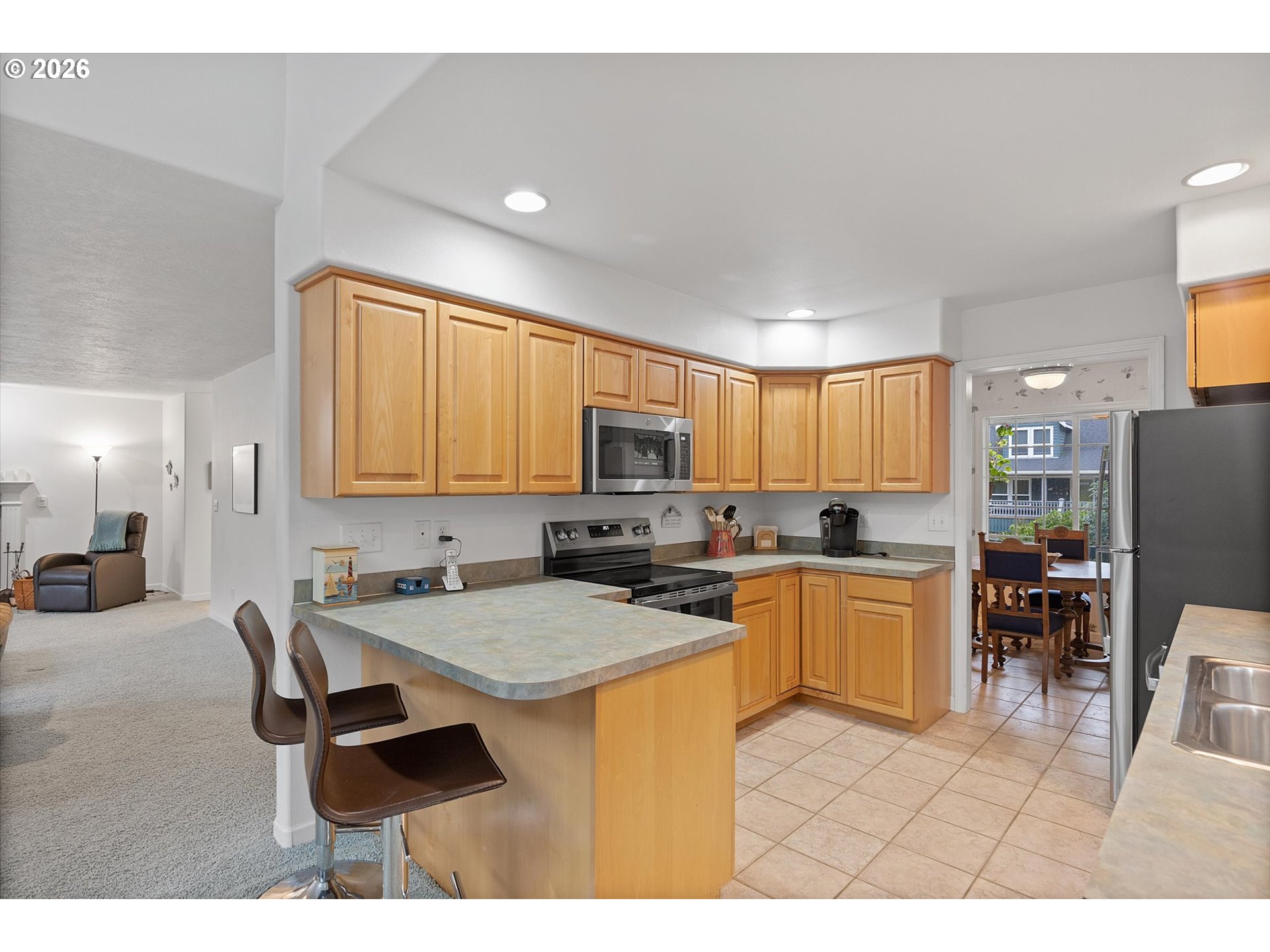 49800 Proposal Rock Loop Neskowin, OR 97149 - Photo 2 of 29 a kitchen with a dining table chairs and a refrigerator